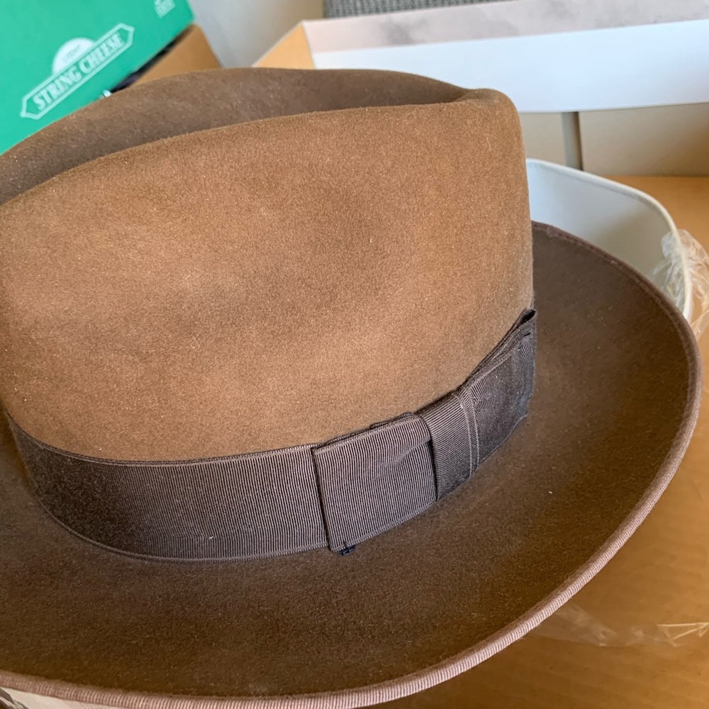 Brown Stetson hat with wide dark brown ribbon trim.